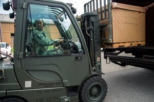 Master Sgt. Agustin Casis, 113th Logistics Readiness Squadron traffic management superintendent, unloads a box of Girl Scout Cookies from a delivery truck on Joint Base Andrews, Md., June 15, 2016. Girl Scouts, from the state of New York, donated approximately 5,000 boxes of cookies to JBA. (U.S. Air Force photo by Airman Gabrielle Spalding)
