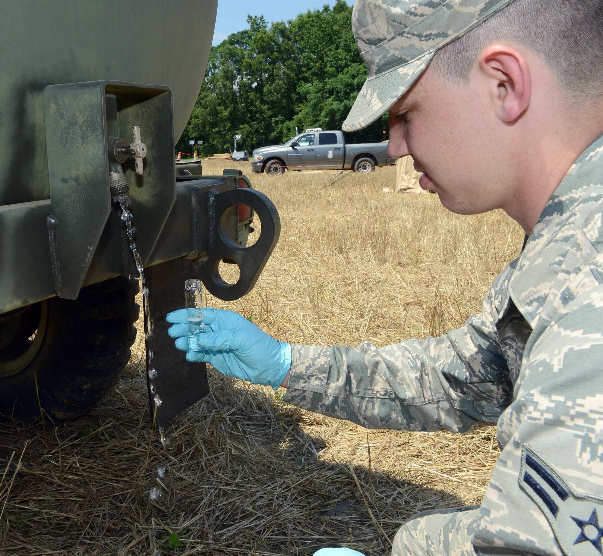 Airman 1st Class William Lavender, 78th Air Base Wing bioenvironmental, tests a sample of potable drinking water from a water trailer delivered to the site by the 5th Combat Communications Group. (U.S. Air Force photo by Tommie Horton)