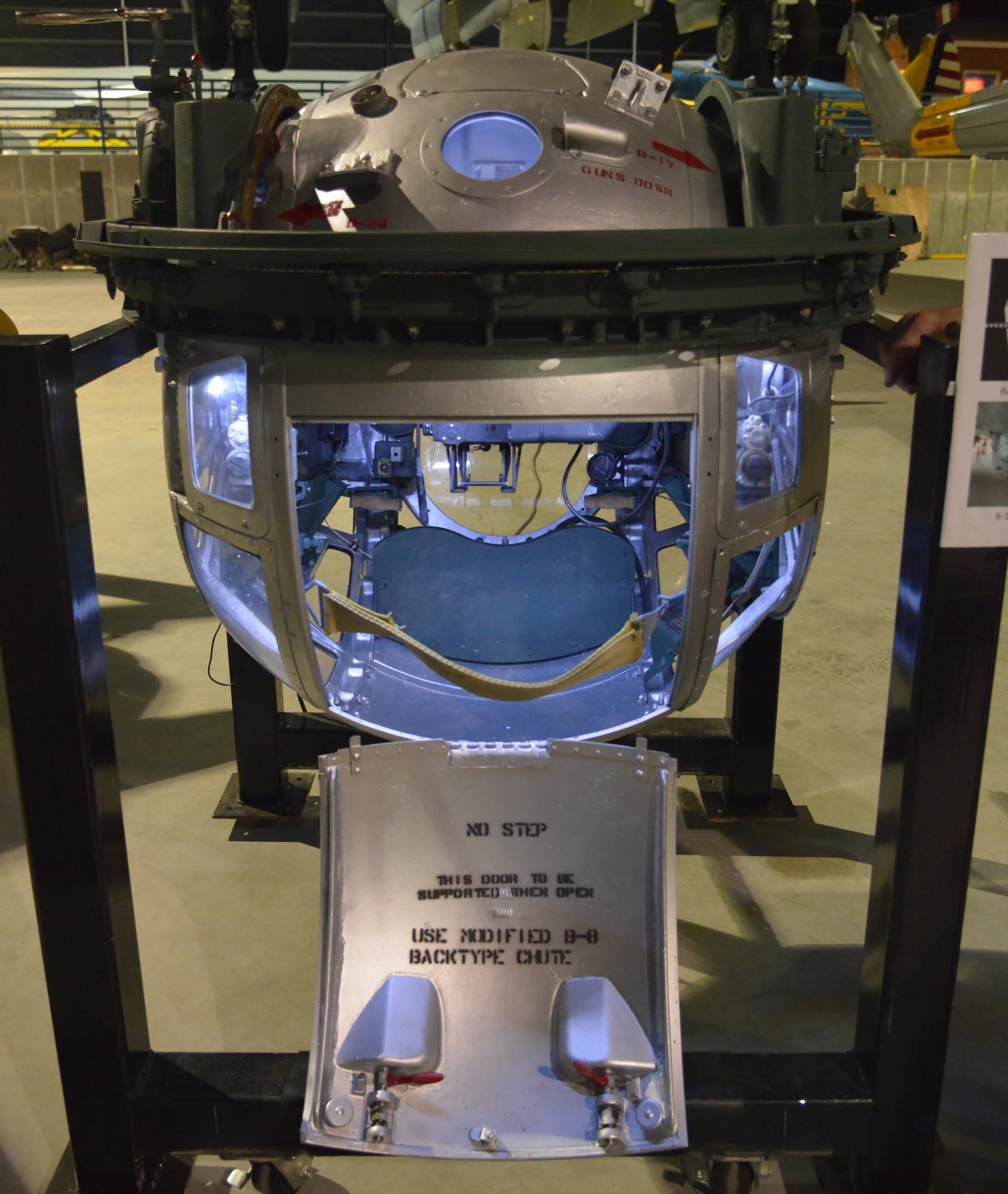 A World War II B-17 ball turret gunner prepares to enter the confining sphere fastened
to the underside of the aircraft known as the ball turret. (U.S. Air Force photo by Ray Crayton)