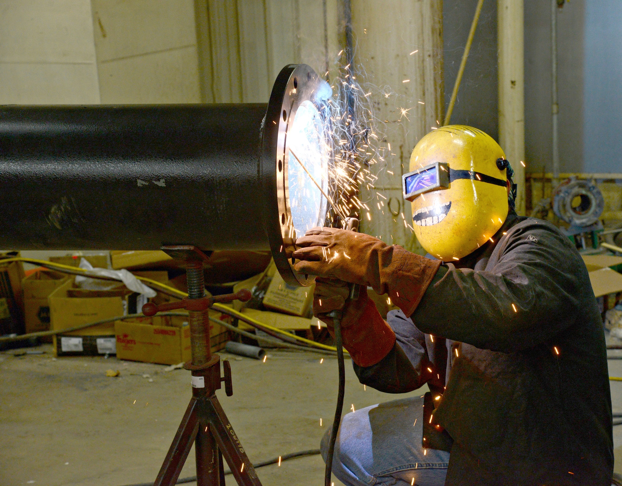 Marc Lyda, with Trade Mechanical, welds an intake for heating water in Bldg. 9301 as part of an energy savings project with Oklahoma Gas & Electric and Honeywell. (Air Force photo by Kelly White)