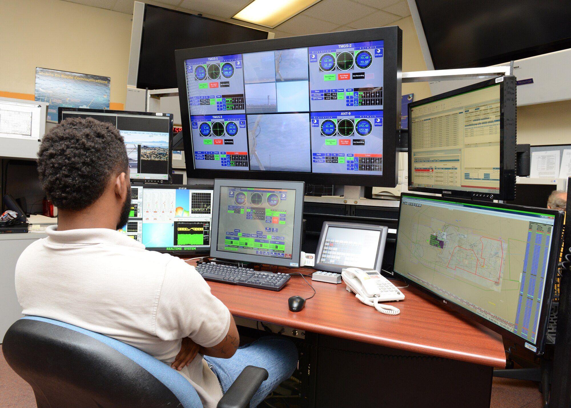 At Ridley Mission Control Center, an employee sits in front of the Single Operator Multiple Antennas station developed by the 412th Range Squadron June 7. SOMA aims to use manpower more efficiently and ultimately save the test wing money by having one operator monitor up to four tracking systems. Thus, freeing up personnel to handle other duties and cross train. (U.S. Air Force photo by Kenji Thuloweit)