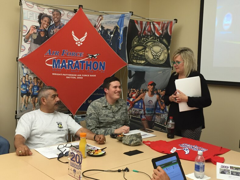 Master Sgt. Antonio Ruiz, Tecumseh High School Air Force JROTC advisor, and Senior Airman Andrew Felix, National Air and Space Intelligence Center, attend the 2016 Air Force Marathon Lead Volunteer Kickoff at the Indu and Raj Soin Medical Center June 8. Leading the meeting is Jeanette Monaghan, Air Force Marathon volunteer coordinator. Ruiz will serve as race day baggage claim coordinator, while Felix plans to volunteer as expo set-up and race day tear-down coordinator. 
(Skywrighter photo/Amy Rollins)
