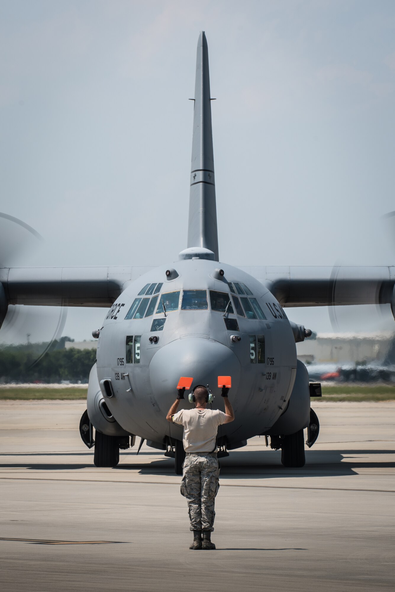 An Airman from the Kentucky Air National Guard’s 123rd Airlift Wing marshals a Connecticut Air National Guard C-130 Hercules aircraft at the Air National Guard’s Air Dominance Center in Savannah, Ga., June 13, 2016. Airmen from the Connecticut unit are participating in Maintenance University here, a weeklong course designed to provide intensive instruction in aircraft maintenance. Now in its eighth year, Maintenance University is sponsored by the 123rd Airlift Wing. (U.S. Air National Guard photo by Lt. Col. Dale Greer)