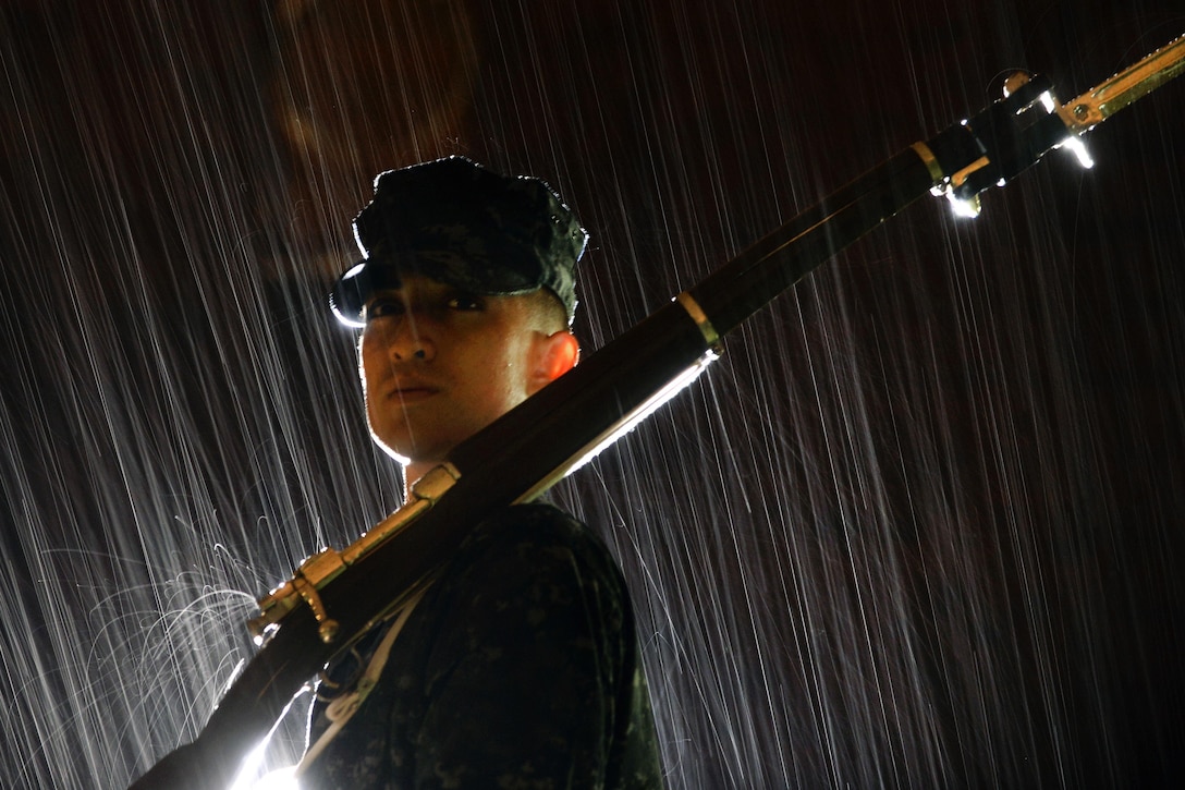 Navy Seaman Joshua Rodriguez participates in drill training during a thunderstorm at Joint Base Anacostia-Bolling, Washington, D.C., June 17, 2016. Rodriguez is assigned to the U.S. Navy's Ceremonial Guard Drill Team. Air National Guard photo by Staff Sgt. Christopher S. Muncy

