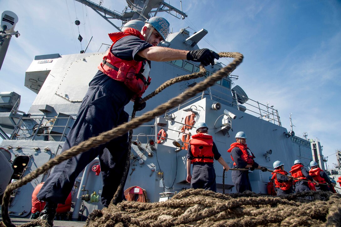 Navy Petty Officer 2nd Class Christopher Arnold coils line as the guided-missile destroyer USS Chung-Hoon conducts a replenishment at sea in the Philippine Sea, June 16, 2016. The Chung-Hoon is on a regularly scheduled deployment in the U.S. 7th Fleet area of responsibility. Navy photo by Petty Officer 1st Class Marcus L. Stanley
