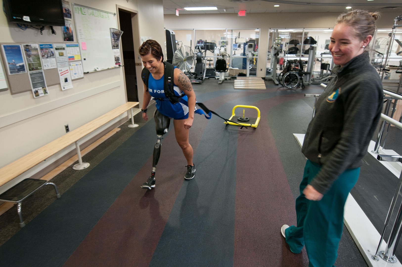 Staff Sgt. Sebastiana Lopez Arellano, a patient at Walter Reed National Military Medical Center, pulls a weighted sled around a track inside the center’s Military Advanced Training Center, which provides amputee patients with state-of-the-art care, in Bethesda, Md., April 13, 2016. Lopez lost her right leg and suffered several other injuries in a motorcycle crash in 2015. She now uses sports and fitness as part of her physical and occupational therapy regimen. (U.S. Air Force photo/Sean Kimmons
