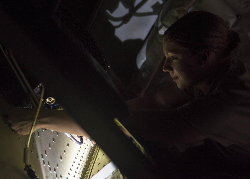 Senior Airman Ashley Frey, 455th Expeditionary Aircraft Maintenance Squadron crew chief, grabs a loose bolt from a safety valve on a C-130J Super Hercules, June 15, 2016, Bagram Airfield, Afghanistan. The safety valve was faulty and needed to be replaced in order to maintain the cabin pressure during flight. (U.S. Air Force photo by Senior Airman Justyn M. Freeman)