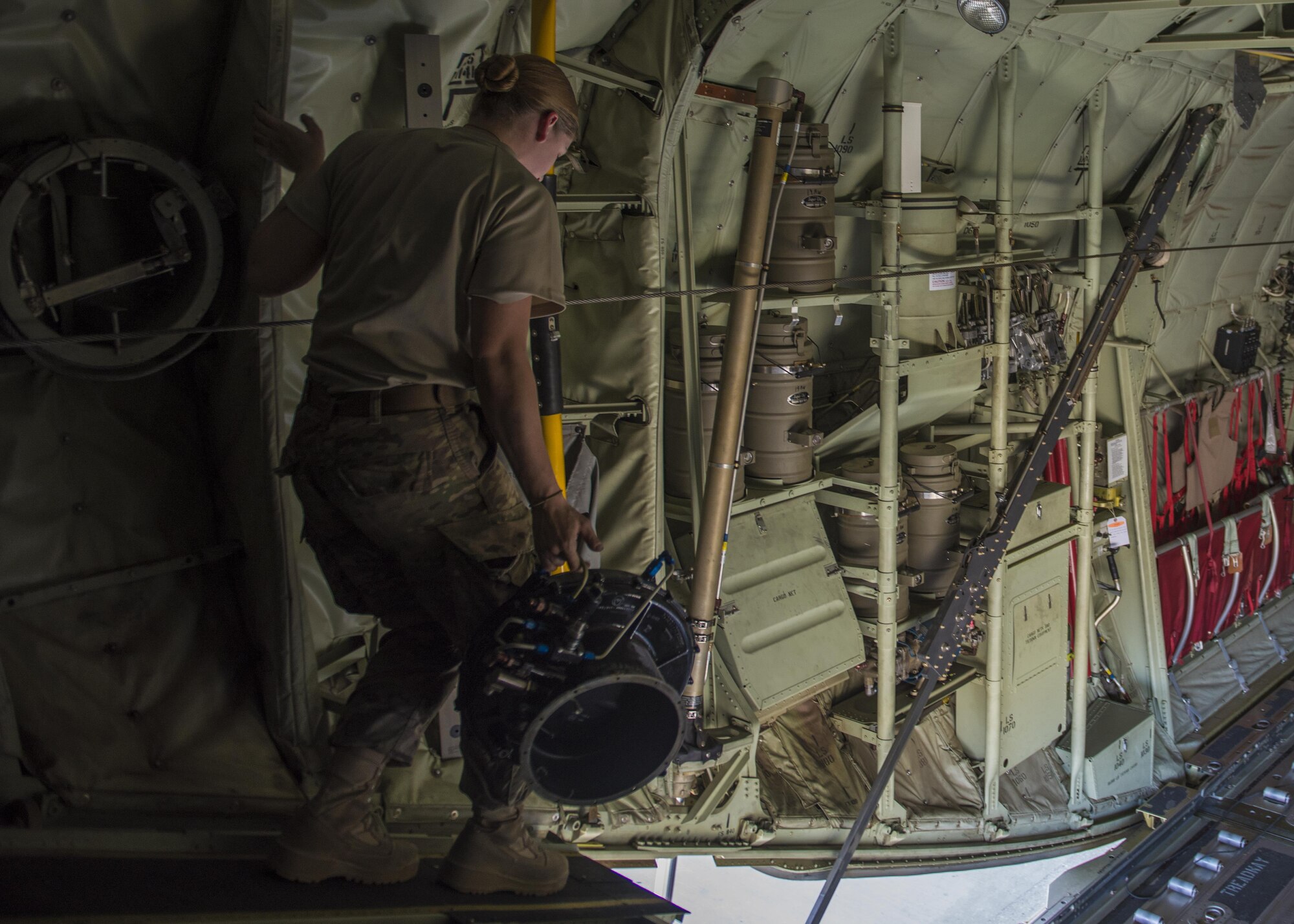 Senior Airman Ashley Frey, 455th Expeditionary Aircraft Maintenance Squadron crew chief, takes the old safety valve down to the main compartment of a C-130J Super Hercules, June 15, 2016, Bagram Airfield, Afghanistan. Members of the 455th EAXMS ensure that aircraft are prepared for flight and return them to a mission-ready state once they land. (U.S. Air Force photo by Senior Airman Justyn M. Freeman)