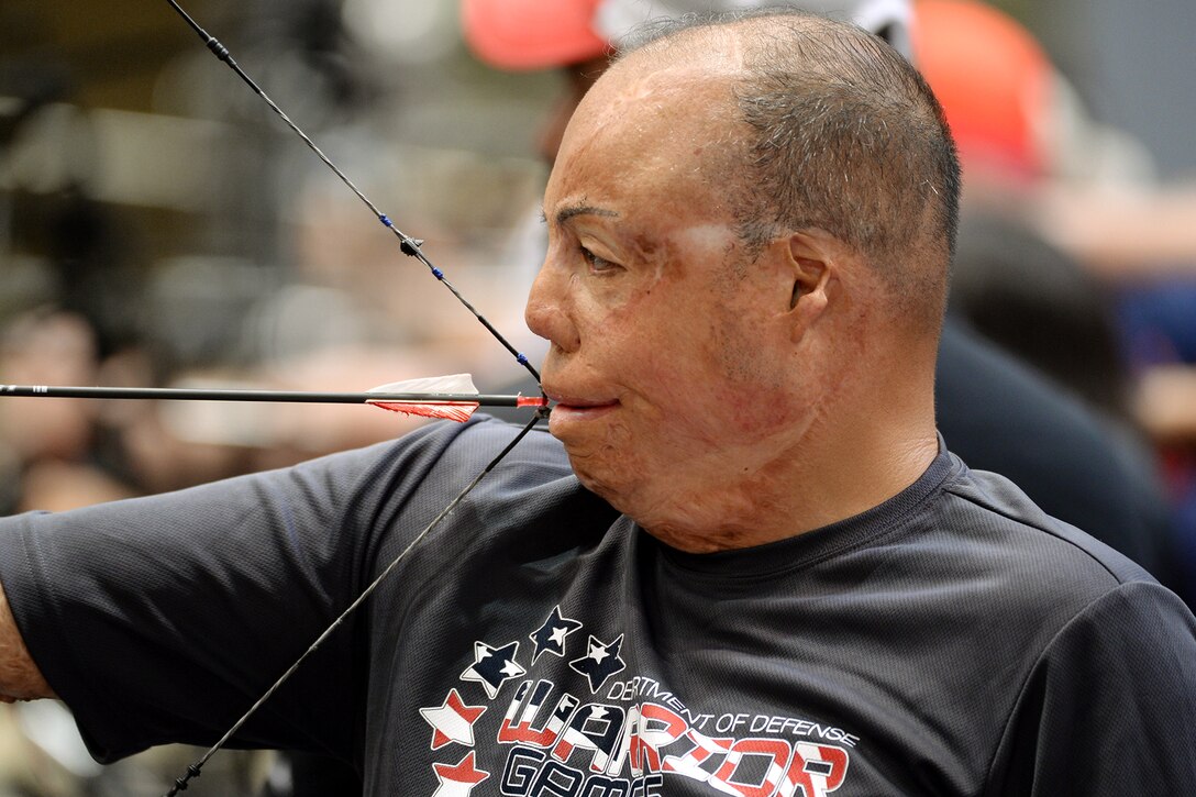 Air Force Master Sgt. Israel Del Toro uses his mouth to shoot archery during the 2016 Department of Defense Warrior Games at the U.S. Military Academy in West Point, N.Y., June 15, 2016. DoD photo by EJ Hersom