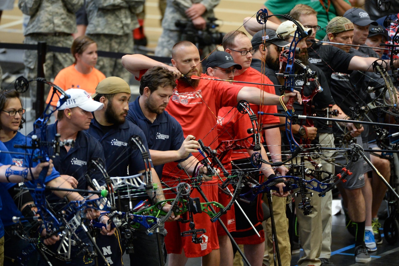 Marine Corps veteran Clayton McDaniel aims his bow in a line of archers competing in the 2016 Department of Defense Warrior Games at the U.S. Military Academy in West Point, N.Y., June 17, 2016. DoD photo by Roger Wollenberg