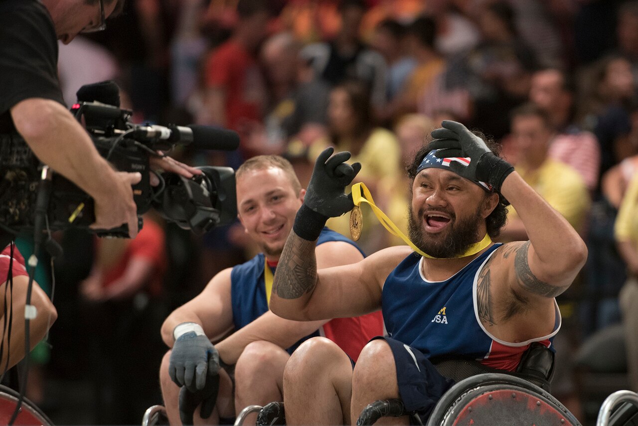 Air Force veteran Leonard Anderson, left, and U.S. Special Operations Command veteran Sualauvi Tuimaoealiiifamo celebrate after the U.S. rugby team defeated Denmark to win the gold medal during the 2016 Invictus Games in Orlando, Fla., May 11, 2016. While competing in the 2016 Department of Defense Warrior Games at the U.S. Military Academy in West Point, N.Y., Tuimaoealiiifamo said adaptive sports have helped him bounce back from his injuries. DoD photo by Roger Wollenberg