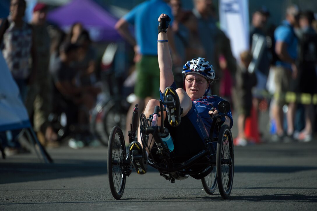 Navy veteran Kathleen “Katie” Ray reacts to crossing the finish line of the 2016 Department of Defense Warrior Games cycling course at the U.S. Military Academy in West Point, N.Y., June 18, 2016. DoD photo by EJ Hersom