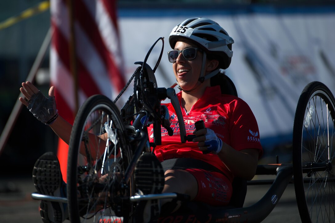 Marine Corps Lance Cpl. Nicole Haikalis reacts to crossing the finish line of the 2016 Department of Defense Warrior Games cycling course at the U.S. Military Academy in West Point, N.Y., June 18, 2016. DoD photo by EJ Hersom