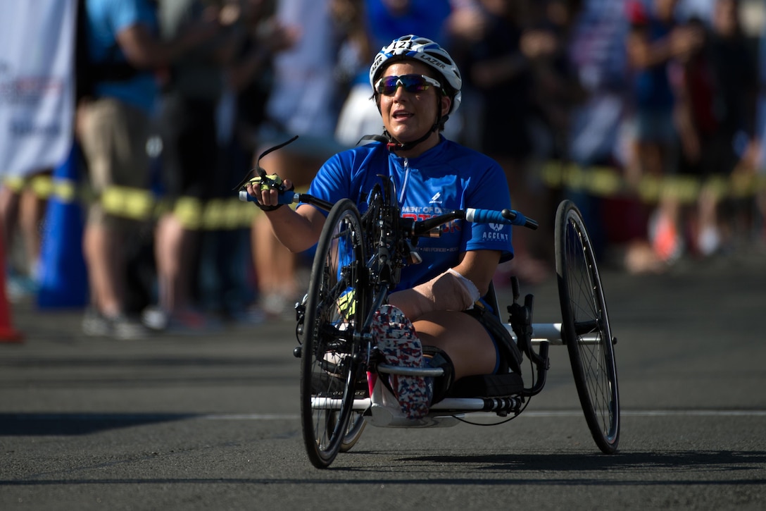 Air Force Staff Sgt. Sebastiana Lopez-Arellano powers a hand cycle through the finish line during the 2016 Department of Defense Warrior Games at the U.S. Military Academy in West Point, N.Y., June 18, 2016. DoD photo by EJ Hersom