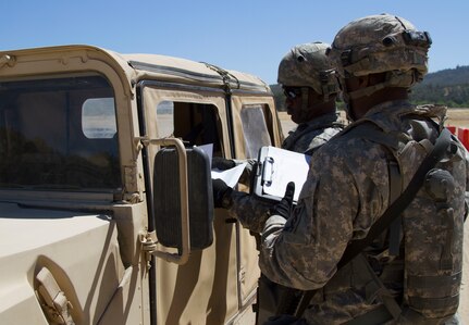 U.S. Army Reserve Spcs. Jahvar Billings and Anthony Clark, 385th Transportation Detachment, Fort Bragg, N.C., inspect a trip ticket at Tactical Assembly Area Schoonover during Combat Support Training Exercise 91-16-02, Fort Hunter Liggett, Calif., June 15, 2016. As the largest U.S. Army Reserve training exercise, CSTX 91-16-02 provides Soldiers with unique opportunities to sharpen their technical and tactical skills in combat-like conditions. (Photo by U.S. Army Spc. Daisy Zimmer, 367th Mobile Public Affairs Detachment)