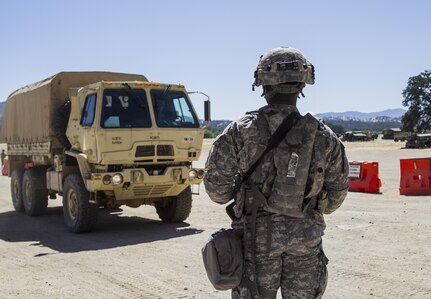 U.S. Army Reserve Spc. Jahvar Billings, 385th Transportation Detachment, Fort Bragg, N.C., directs a Light Medium Tactical Vehicle to the trip ticket checkpoint at Tactical Assembly Area Schoonover during Combat Support Training Exercise 91-16-02, Fort Hunter Liggett, Calif., June 15, 2016. As the largest U.S. Army Reserve training exercise, CSTX 91-16-02 provides Soldiers with unique opportunities to sharpen their technical and tactical skills in combat-like conditions. (Photo by U.S. Army Spc. Daisy Zimmer, 367th Mobile Public Affairs Detachment)