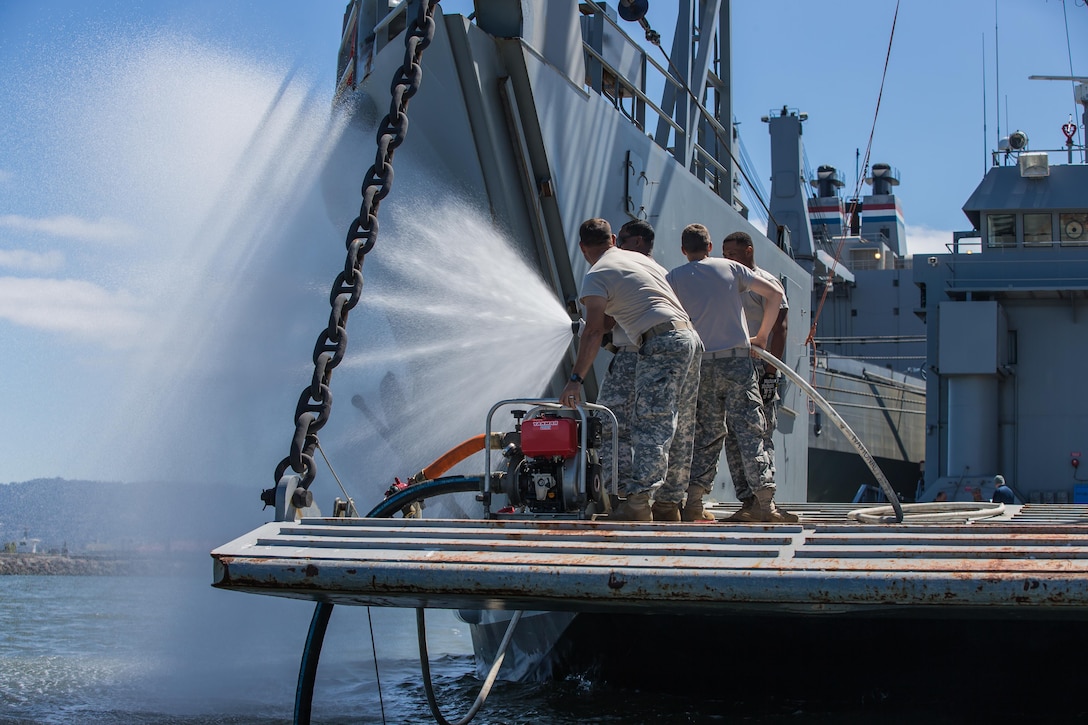 U.S. Army Reserve Soldiers with the 481st Transportation Company, test a fire hose on landing craft utility 2000 USAV Palo Alto during training at the Big Logistics Over The Shore, West exercises at Alameda, Calif., Aug. 3, 2015. Big Logistics Over-The-Shore, West is an annual, Army Reserve, functional exercise designed for transportation units and sustainment commands to hone their expertise in Logistics Over-the-Shore operations from July 25 to Aug. 7, 2015. More than 750 Soldiers are participating this year. The exercise has grown into a multi-component exercise involving elements from the Active Component Army, U.S. Navy, U.S. Air Force, U.S. Coast Guard, and U.S. Maritime Administration are conducting operations at three Bay-Area California training locations: Camp Parks, Alameda Point, and Military Ocean Terminal-Concord (MOTCO).