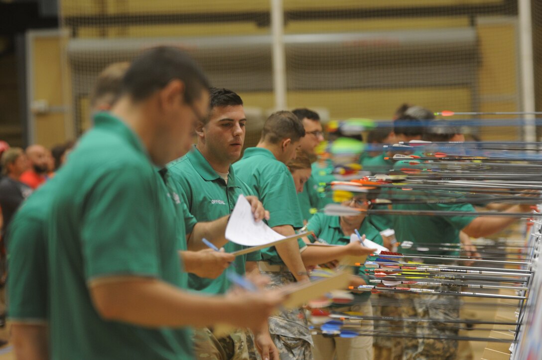 The 2016 DoD Warrior Games includes archery, both recurve bow and compound bow. The Games, running from June 15-21,  are a Paralympic-type event for wounded, ill and injured personnel from the military representing all four U.S. Services, Special Operations Command and the United Kingdom. Pictured here, scorers determine the points scored after a round of arrows have been shot.