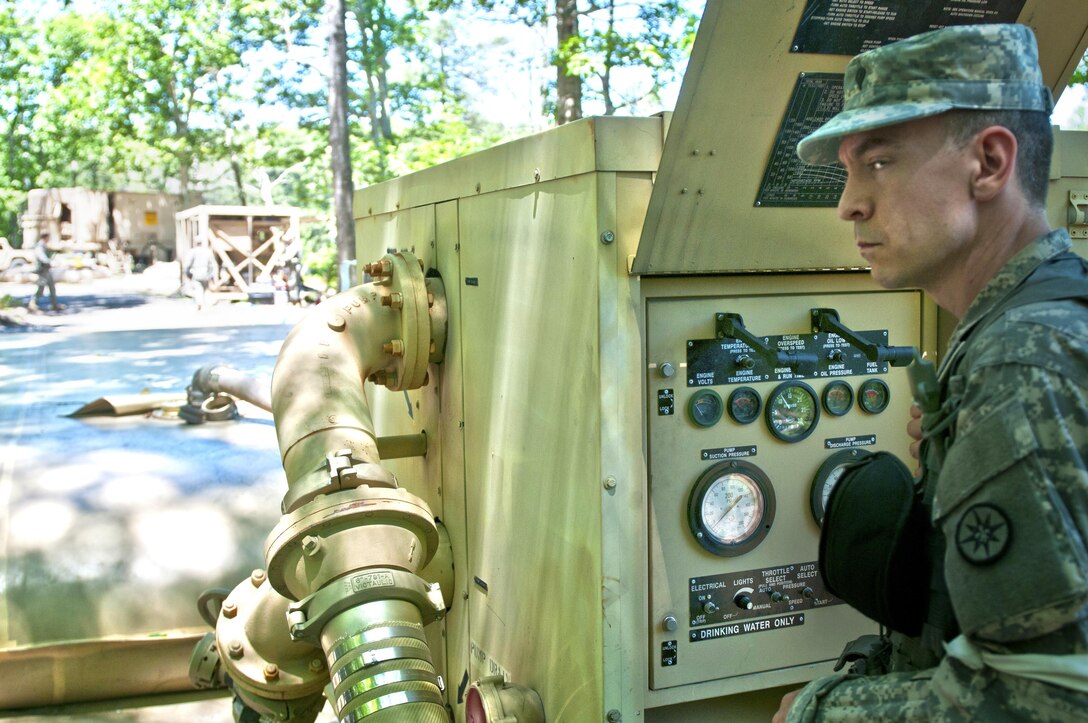 Spc. Peter Grafius, a quartermaster and chemical equipment repairer with the 401st Quartermaster Detachment, pays listens to commands while operating a water pump during the annual U.S. Army Reserve Quartermaster Liquid Logistics Exercise (QLLEX) at Fort. A.P. Hill, Va., June 18, 2016. (U.S. Army photo by Staff Sgt. Dalton Smith/Released)