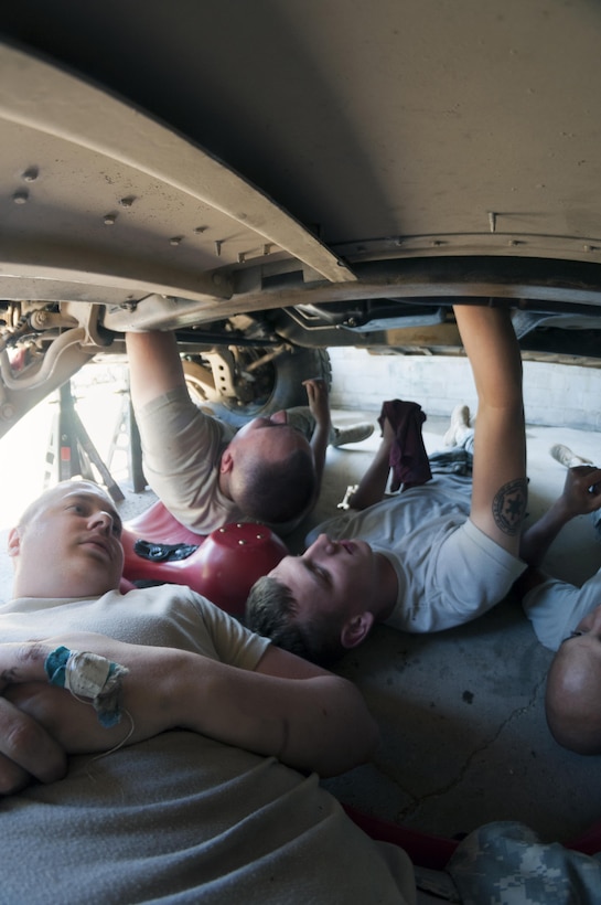 Private 1st Class Dalton Peake (Left), a wheeled vehicle mechanic with the 327th Quartermaster Battalion repairs a Humvee with Spec. Jacob Sexton (Middle) and Spec. Eric Sander, light wheeled vehicle mechanics with the 254th Quartermaster Company, during the annual Quartermaster Liquid Logistics Exercise at Fort A.P. Hill, VA. June 18, 2016.(Sgt. Christopher Bigelow/Released)