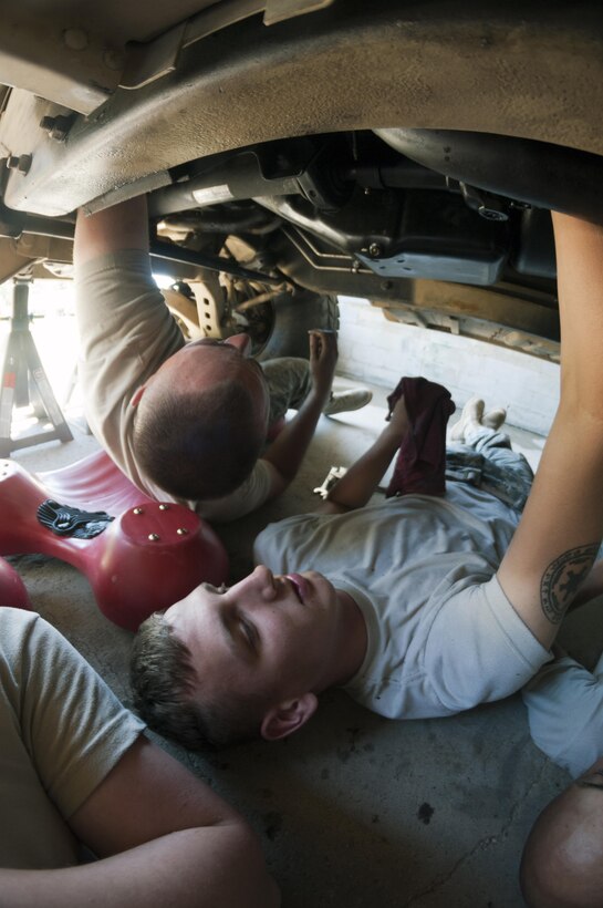 Spec. Jacob Sexton and Spec. Eric Sander, light wheeled vehicle mechanics with the 254th Quartermaster Company, repair a Humvee during the annual Quartermaster Liquid Logistics Exercise at Fort A.P. Hill, VA. June 18, 2016.(Sgt. Christopher Bigelow/Released)