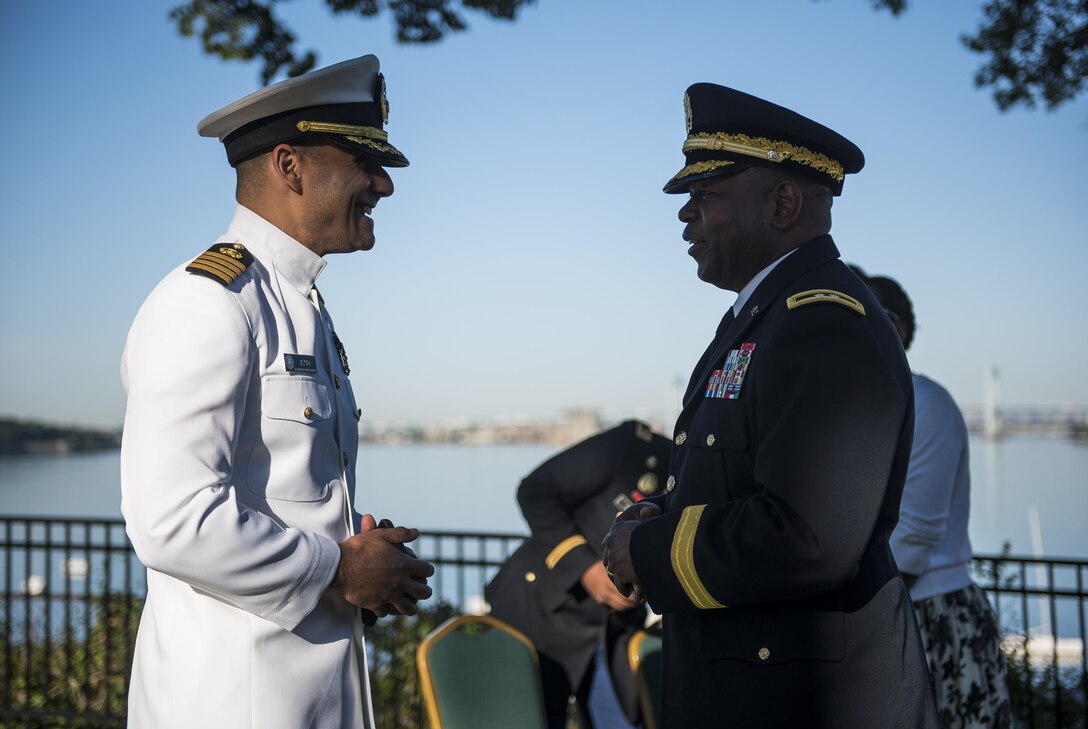 Maj. Gen. Phillip Churn (right), commanding general of the 200th Military Police Command, U.S. Army Reserve, a native of Washington, D.C., talks with U.S. Navy Capt. David Sosa, commandant of the U.S. Merchant Marine Academy, before a private commissioning ceremony hosted for six U.S. Army officers and graduates at Kings Point, New York, June 18. The 2016 graduating class included 229 senior midshipmen, each earning a Bachelor of Science degree, a direct commission into the armed forces and a U.S. Coast Guard license. (U.S. Army photo by Master Sgt. Michel Sauret)