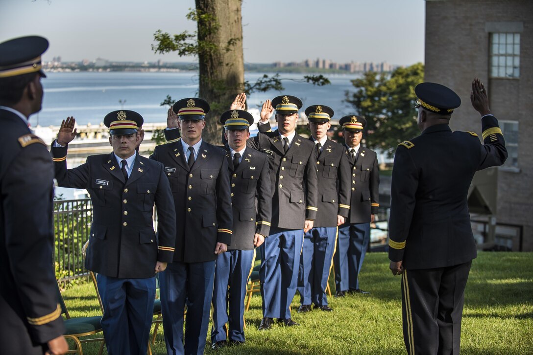 Maj. Gen. Phillip Churn, commanding general of the 200th Military Police Command, U.S. Army Reserve, a native of Washington, D.C., administers the Oath of Commissioned Officers to a group of six midshipmen commissioning into the U.S. Army at the U.S. Merchant Marine Academy in Kings Point, New York, during a private commissioning ceremony June 18. Three of the lieutenants joined the engineering branch in the U.S. Army Reserve and will belong to the 306th Engineer Company (Vertical), belonging to the 412th Theater Engineer Command. (U.S. Army photo by Master Sgt. Michel Sauret)