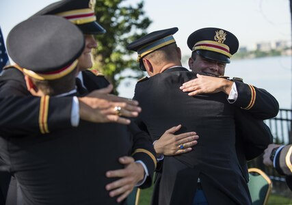 A group of lieutenants who just commissioned into the U.S. Army congratulate one another at the U.S. Merchant Marine Academy in Kings Point, New York, during a private commissioning ceremony June 18. Maj. Gen. Phillip Churn, commanding general of the 200th Military Police Command, U.S. Army Reserve, a native of Washington, D.C., administered the Oath of Commissioned Officers for the Army lieutenants. Three of the lieutenants joined the engineering branch in the U.S. Army Reserve and will belong to the 306th Engineer Company (Vertical), belonging to the 412th Theater Engineer Command. (U.S. Army photo by Master Sgt. Michel Sauret)