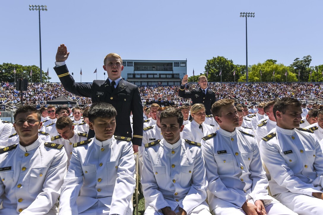 U.S. Army lieutenants take the Oath of the Commissioned Officer for the second time that day during their graduation ceremony at the U.S. Merchant Marine Academy in Kings Point, New York, June 18. Maj. Gen. Phillip Churn, commanding general of the 200th Military Police Command, U.S. Army Reserve, a native of Washington, D.C., administered the Oath of Commissioned Officers for six Army lieutenants. The 2016 graduating class included 229 senior midshipmen, each earning a Bachelor of Science degree, a direct commission into the armed forces and a U.S. Coast Guard license. (U.S. Army photo by Master Sgt. Michel Sauret)