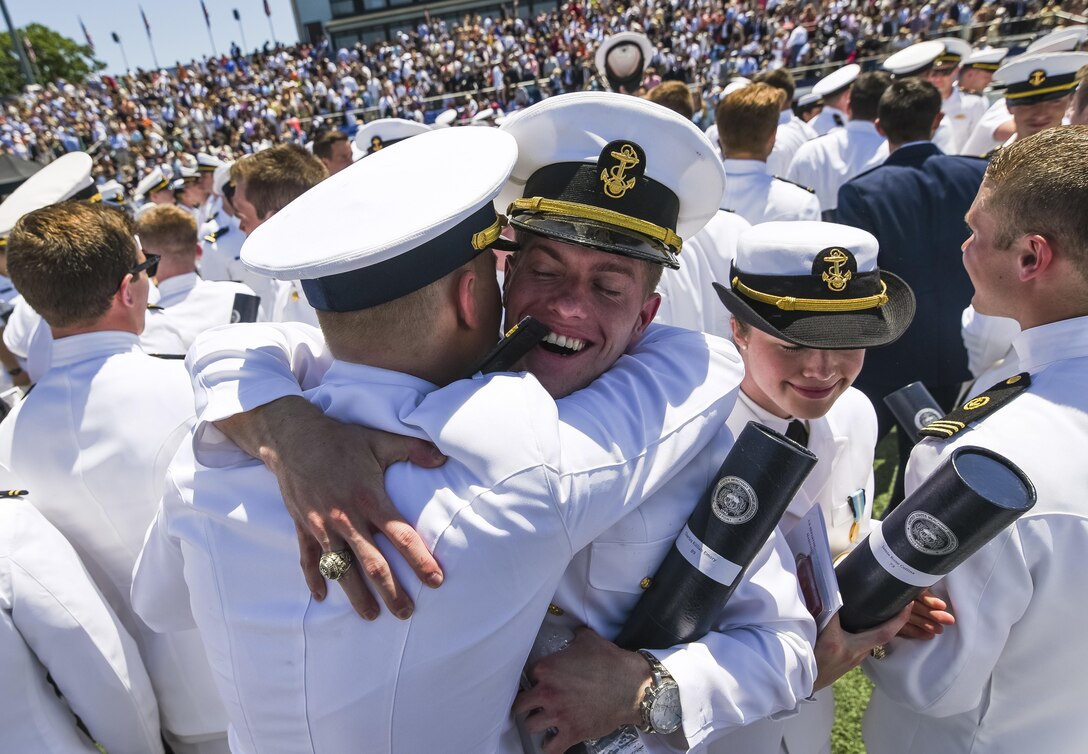 Newly commissioned ensigns cheer and congratulate one another after graduating from the U.S. Merchant Marine Academy in Kings Point, New York, June 18. The 2016 graduating class included 229 senior midshipmen, each earning a Bachelor of Science degree, a direct commission into the armed forces and a U.S. Coast Guard license. (U.S. Army photo by Master Sgt. Michel Sauret)