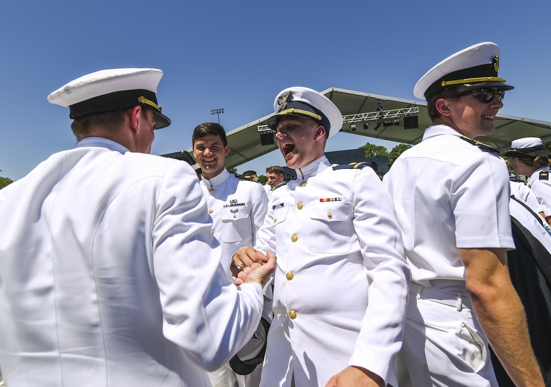 Newly commissioned ensigns cheer and congratulate one another after graduating from the U.S. Merchant Marine Academy in Kings Point, New York, June 18. The 2016 graduating class included 229 senior midshipmen, each earning a Bachelor of Science degree, a direct commission into the armed forces and a U.S. Coast Guard license. (U.S. Army photo by Master Sgt. Michel Sauret)