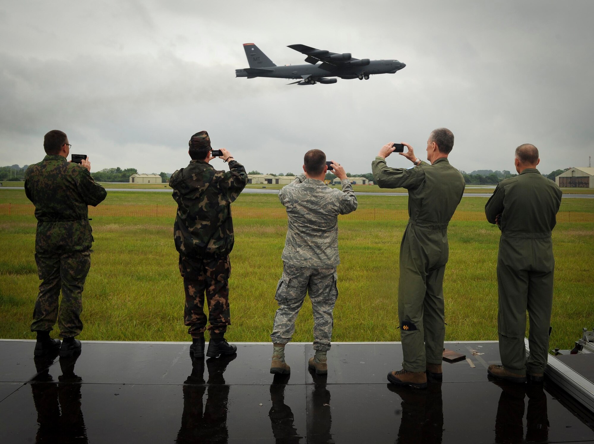 Defense attaché members photograph a B-52H Stratofortress take off from RAF Fairford, United Kingdom, June 17, 2016. After the takeoff, 5th Expeditionary Operations Group leadership briefed the B-52 capabilities and explained the purpose of bomber presence for multinational exercises BALTOPS 16 and Saber Strike 16. (U.S. Air Force photo/Senior Airman Sahara. L. Fales)
