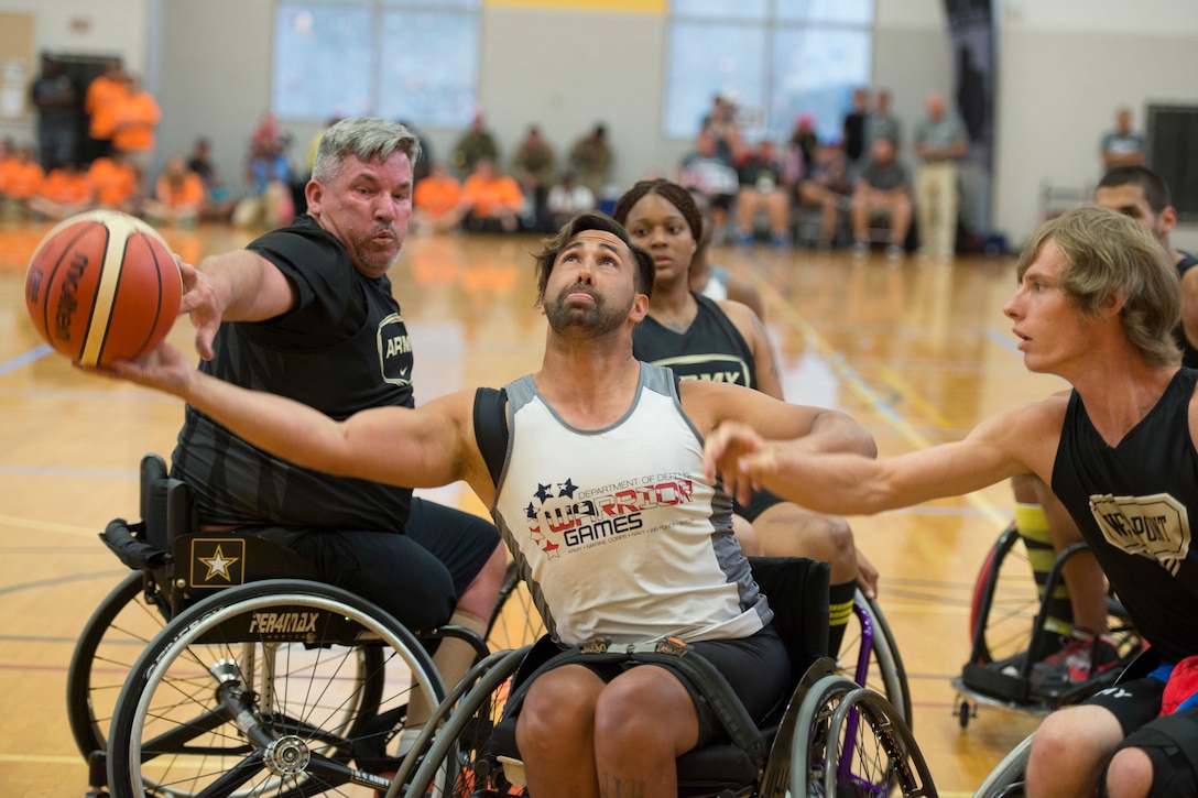 Army veterans Chris Parks, left, and Terry Cartwright, block veteran Howard Sanborn, center, representing Southern Command in wheelchair basketball at the 2016 Department of Defense Warrior Games at the U.S. Military Academy in West Point, N.Y., June 18, 2016. DoD photo by Roger Wollenberg