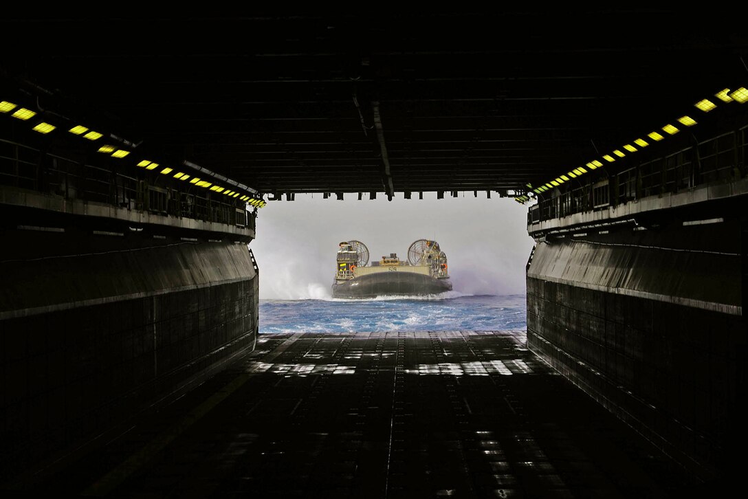 A landing craft air cushion vehicle prepares to enter the well deck of the amphibious assault ship USS Boxer in the Arabian Gulf, June 18, 2016. Navy photo by Seaman Eric Burgett