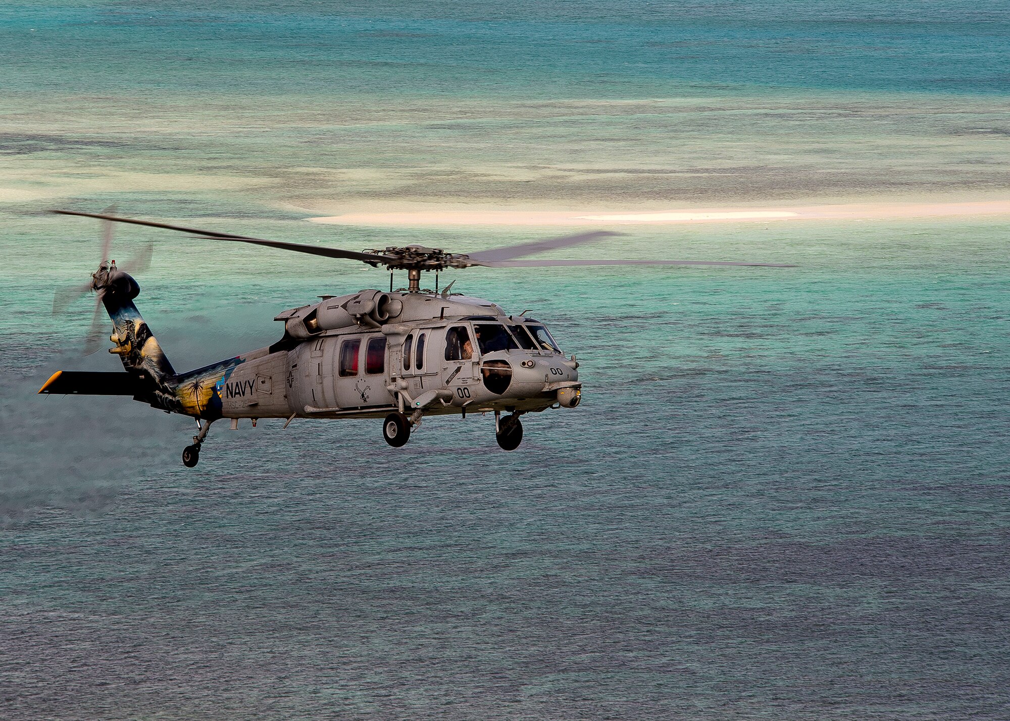 An MH-60S Sea Hawk helicopter assigned to the Island Knights of Helicopter Sea Combat Squadron (HSC) 25 is pictured during a photo exercise off the coast of Guam. HSC-25 maintains a 24-hour search and rescue and medical evacuation alert posture, directly supporting the U.S. Coast Guard, Sector Guam and Joint Region Marianas. HSC-25 ensures maritime peace and security in the U.S. 7th Fleet area of responsibility. (U.S. Navy photo by Chief Mass Communication Specialist Joan E. Jennings/Released) 