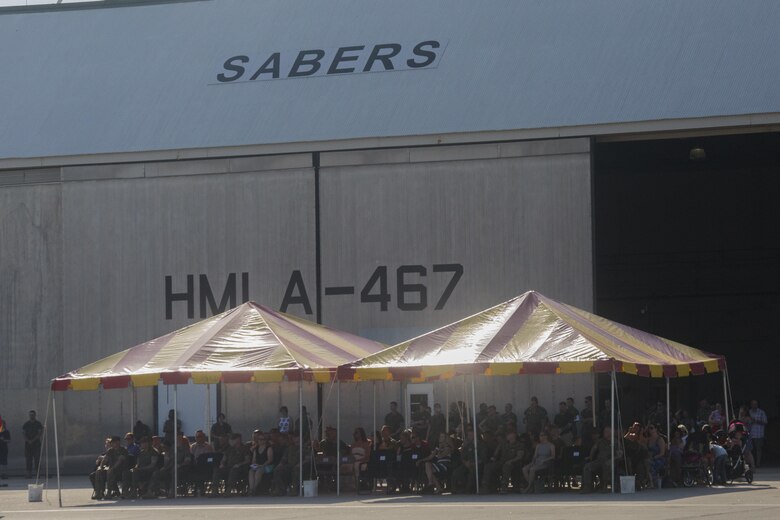 Friends and family of Marines and sailors with Marine Light Attack Helicopter Squadron 467 watch from the viewing area along the flight line during the deactivation ceremony at Marine Corps Air Station New River, N.C., June 16, 2016.  After eight years of service under 2nd Marine Air Wing and supporting the global war on terror, the unit will disband and Marines will scatter throughout various other attack squadrons throughout the Marine Corps.