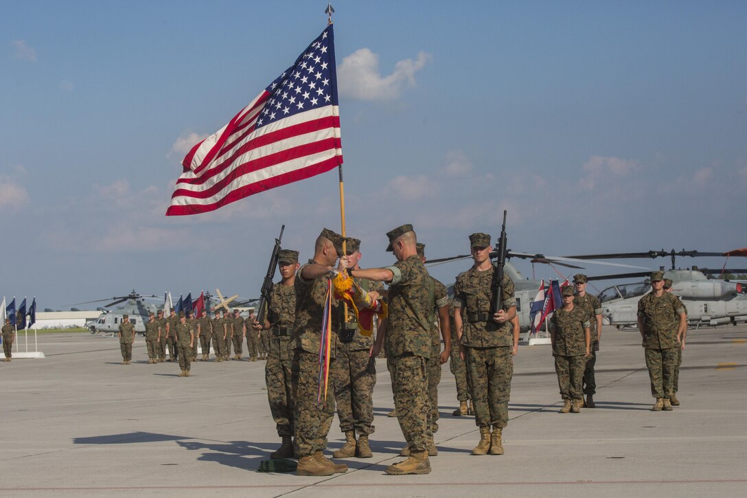Lieutenant Colonel David B. Moore, (right), the commanding officer of Marine Light Attack Helicopter Squadron 467, and Sgt. Maj. John M. Kennedy, the squadron sergeant major, case the units’ colors during the deactivation ceremony of HMLA-467 at Marine Corps Air Station New River, N.C., June 16, 2016. The squadron served in numerous theaters to include supporting unit deployment programs in Japan, attaching to Marine Expeditionary Units, and providing security to ground troops during Operation Enduring Freedom in Afghanistan.
