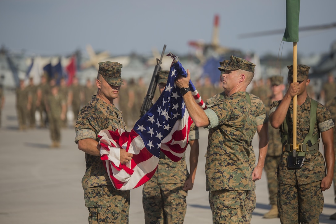 Lieutenant Colonel David B. Moore, (right), the commanding officer of Marine Light Attack Helicopter Squadron 467, and Sgt. Maj. John M. Kennedy, the squadron sergeant major, case the colors during the deactivation ceremony of HMLA-467 at Marine Corps Air Station New River, N.C., June 16, 2016. The squadron served in numerous theaters to include supporting unit deployment programs in Japan, attaching to Marine Expeditionary Units, and providing security to ground troops during Operation Enduring Freedom in Afghanistan.