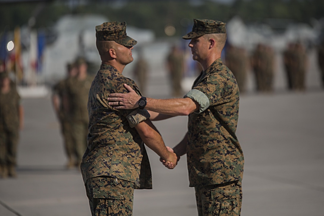 Lieutenant Colonel David B. Moore, (right), the commanding officer of Marine Light Attack Helicopter Squadron 467, and Sgt. Maj. John M. Kennedy, the squadron sergeant major, shake hands for the last time serving as the unit's leaders during the deactivation ceremony of HMLA-467 at Marine Corps Air Station New River, N.C., June 16, 2016. The squadron served in numerous theaters to include supporting unit deployment programs in Japan, attaching to Marine Expeditionary Units, and providing security to ground troops during Operation Enduring Freedom in Afghanistan.
