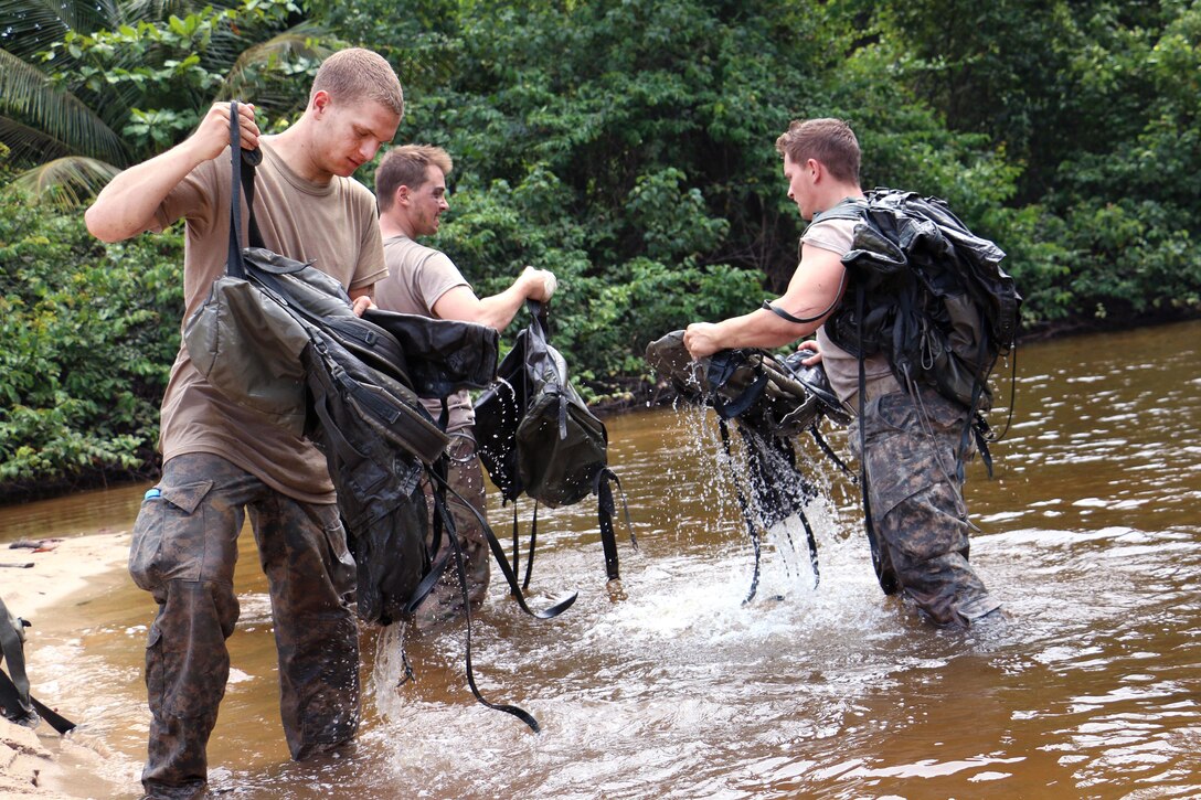 U.S. soldiers rinse their rucksacks in Corisco Bay off the coast of Gabon, June 10, 2016, after participating in an obstacle course at the French jungle warfare school. Army photo by Staff Sgt. Candace Mundt