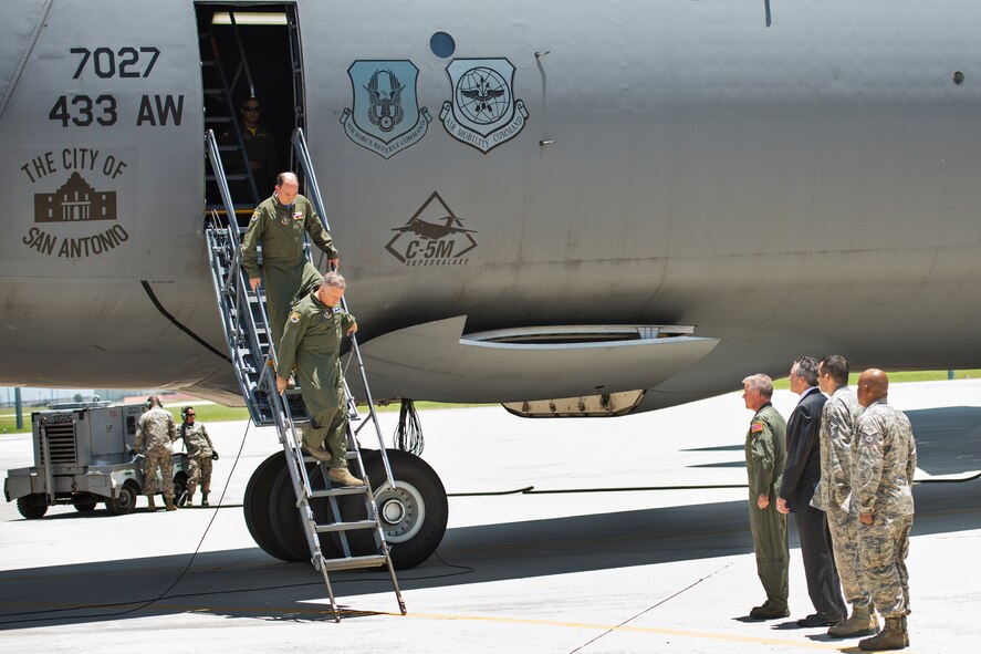 Maj. Gen. John C. Flournoy Jr., 4th Air Force commander, followed by Col. Thomas K. Smith Jr., 433rd AW commander, depart the Alamo Wing's first C-5M Super Galaxy, bestowed "The City of San Antonio" June 17, 2016 at Joint Base San Antonio-Lackland, Texas. The crew flew the maiden flight from Stewart Air National Guard Base, New York, earlier that day before their arrival at the official aircraft transfer ceremony. (U.S. Air Force photo by Benjamin Faske)
