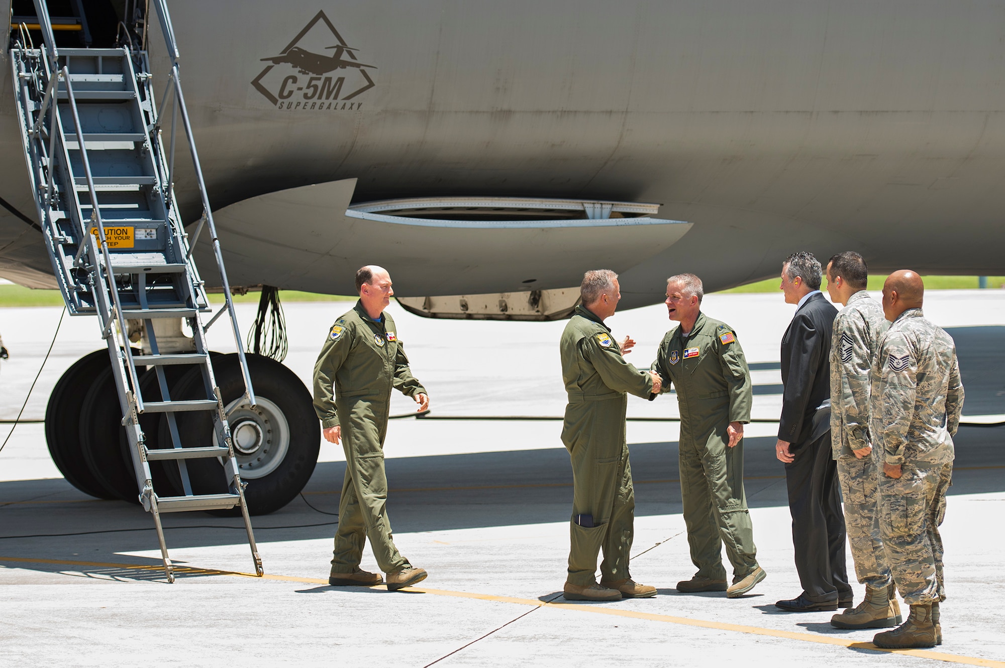 Maj. Gen. John Flournoy, 4th Air Force commander, shakes hands with Col. David Scott, 433rd Airlift Wing vice commander, after departing the Alamo Wing's first C-5M Super Galaxy, bestowed "The City of San Antonio" June 17, 2016 at Joint Base San Antonio-Lackland, Texas. In total, the 433rd AW will receive nine C-5M models by late 2018, which is the result of a two-phase modernization effort that will improve fuel savings, climb rate, payload capability, and noise reduction.  (U.S. Air Force photo by Benjamin Faske) 