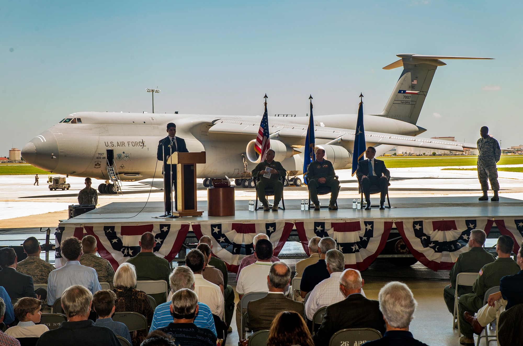 San Antonio City Council member Rey Saldana, District 4, reads a proclamation on behalf of the city to the 433rd Airlift Wing welcoming its first C-5M Super Galaxy June 17, 2016 during the transfer ceremony along the flight line at Joint Base San Antonio-Lackland, Texas. The 433rd AW will receive nine C-5M models which is the result of a two-phase modernization effort that will improve fuel savings, climb rate, payload capability, and noise reduction.  (U.S. Air Force photo by Benjamin Faske) 
