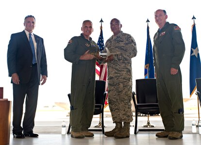 Maj. Gen. John C. Flournoy Jr., 4th Air Force commander, presents Tech. Sgt. David Ponce, 433rd Aircraft Maintenance Squadron crew chief, with the ceremonial key to the first C-5M Super Galaxy aircraft, bestowed "The City of San Antonio" June 17, 2016 at Joint Base San Antonio-Lackland, Texas. The 433rd AW will receive nine C-5M models which is the result of a two-phase modernization effort that will improve fuel savings, climb rate, payload capability, and noise reduction. (U.S. Air Force photo by Benjamin Faske) 