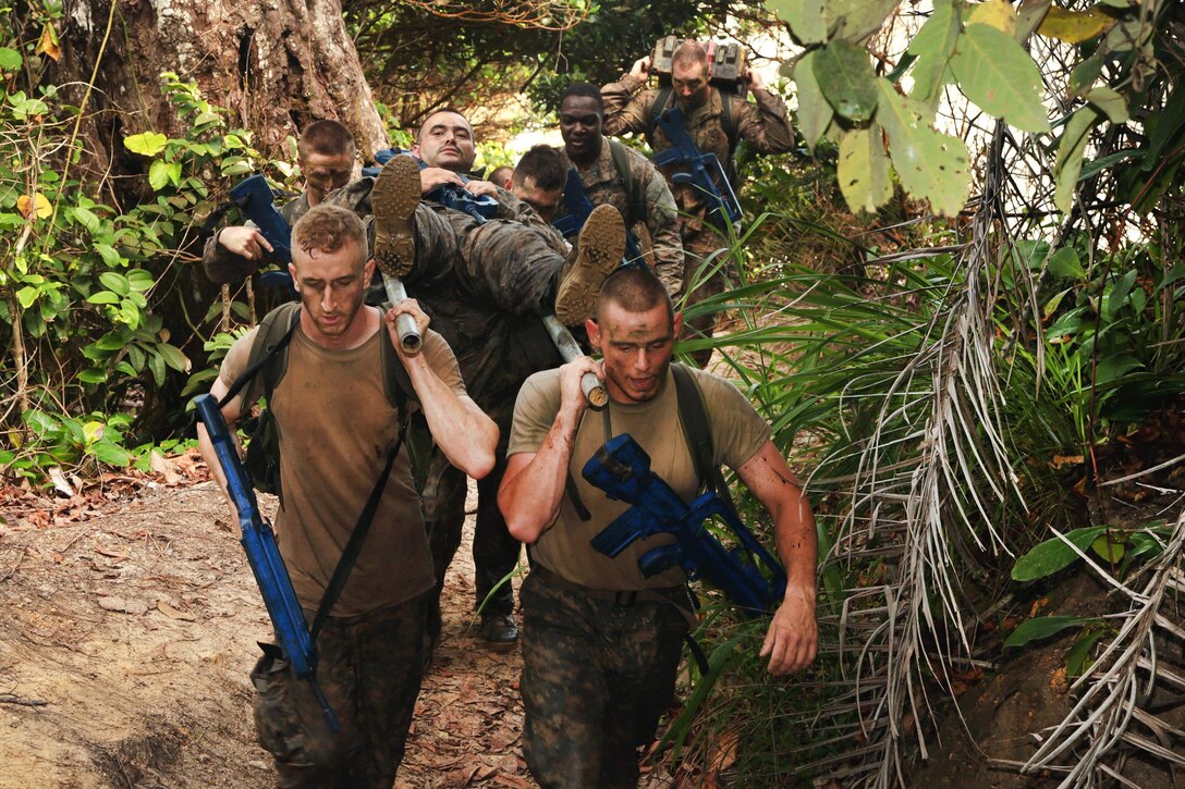 U.S. soldiers evacuate a mock casualty during a team obstacle course event at the French jungle warfare school in Gabon, June 10, 2016. Army photo by Spc. Yvette Zabala-Garriga