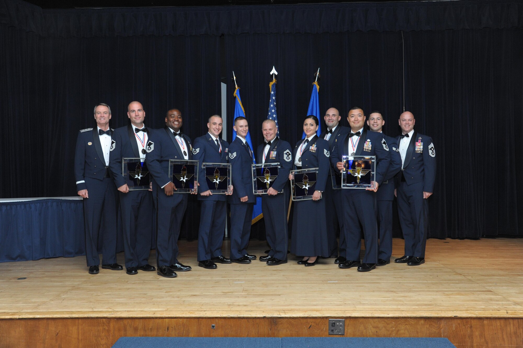 Lt. Gen. Darryl Roberson, commander, Air Education and Training Command and AETC Command Chief Master Sgt. David Staton pose for a photo with the AETC Outstanding Airmen of the Year at a ceremony here, June 16. The award distinguishes AETC’s enlisted Airmen for their leadership, job performance, community involvement and personal achievements. (U.S. Air Force photo by Joel Martinez)