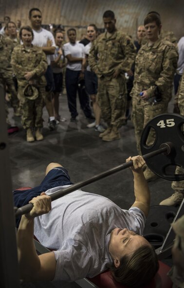 Military personnel cheer on Master. Sgt. Lindsey Glover, 455th Expeditionary Aircraft Maintenance Squadron, as she completes her second benchpress lift during the Strongest Woman and Man competition, June 18, 2016, Bagram Airfield, Afghanistan. Glover was the overall winner for the squat, benchpress and deadlift, women’s division. She will go on to compete in the Strongest in the AOR (area of responsibility) contest. (U.S. Air Force photo by Tech. Sgt. Tyrona Lawson)