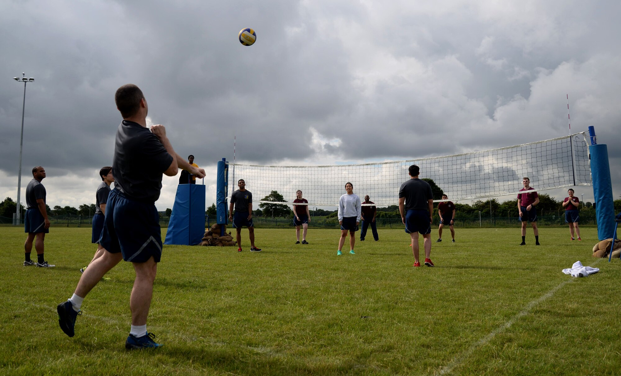 U.S. Air Force Airmen compete in an outdoor volleyball tournament as part of the 2016 Marauder Melee Family Sports Day June 16, 2016, on RAF Mildenhall. Squadron teams aimed to place top three in each event to accumulate the most points. Other sports events included ping pong, basketball, bowling and tug-of-war. (U.S. Air Force photo by Senior Airman Justine Rho/Released)  