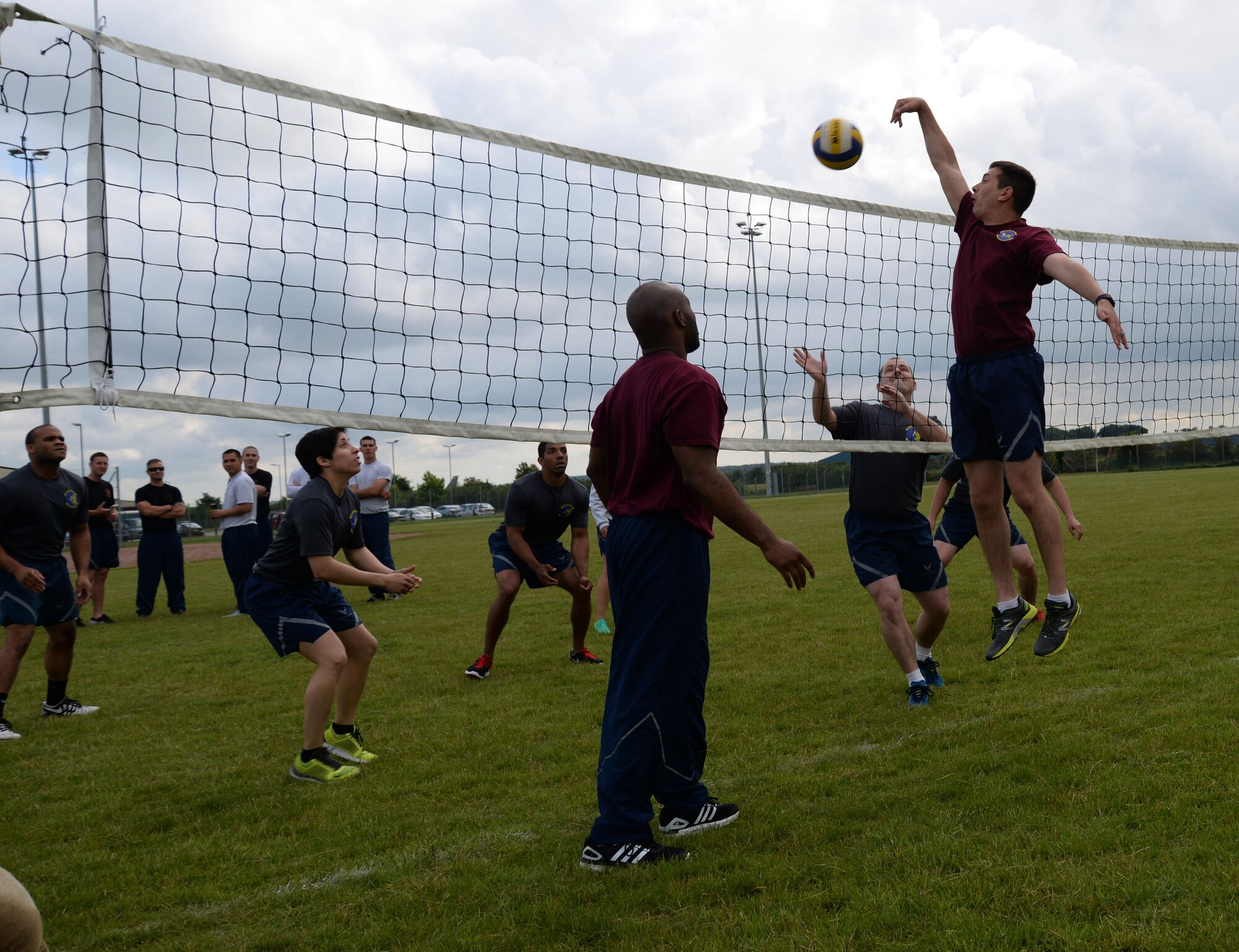U.S. Air Force Airmen compete in an outdoor volleyball tournament as part of the 2016 Marauder Melee Family Sports Day June 16, 2016, on RAF Mildenhall. Squadron teams aimed to place top three in each event to accumulate the most points. Other sports events included ping pong, basketball, bowling and tug-of-war. (U.S. Air Force photo by Senior Airman Justine Rho/Released)  