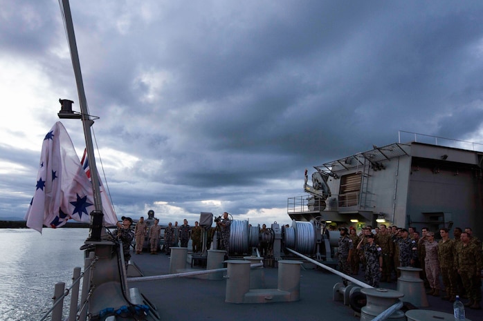 U.S. Marines, Australian soldiers and Australian sailors stand at attention for the lowering of the Australian flag aboard the HMAS Adelaide at Port of Brisbane, Queensland, Australia, June 16, 2016. This marks the first time Marines and sailors from Marine Rotational Force - Darwin have embarked in such numbers on an Australian HMAS. This opportunity allows for MRF-D to expand the partnership capabilities with our Australian allies. The Marines are with 1st Battalion, 1st Marine Regiment, MRF-D. 